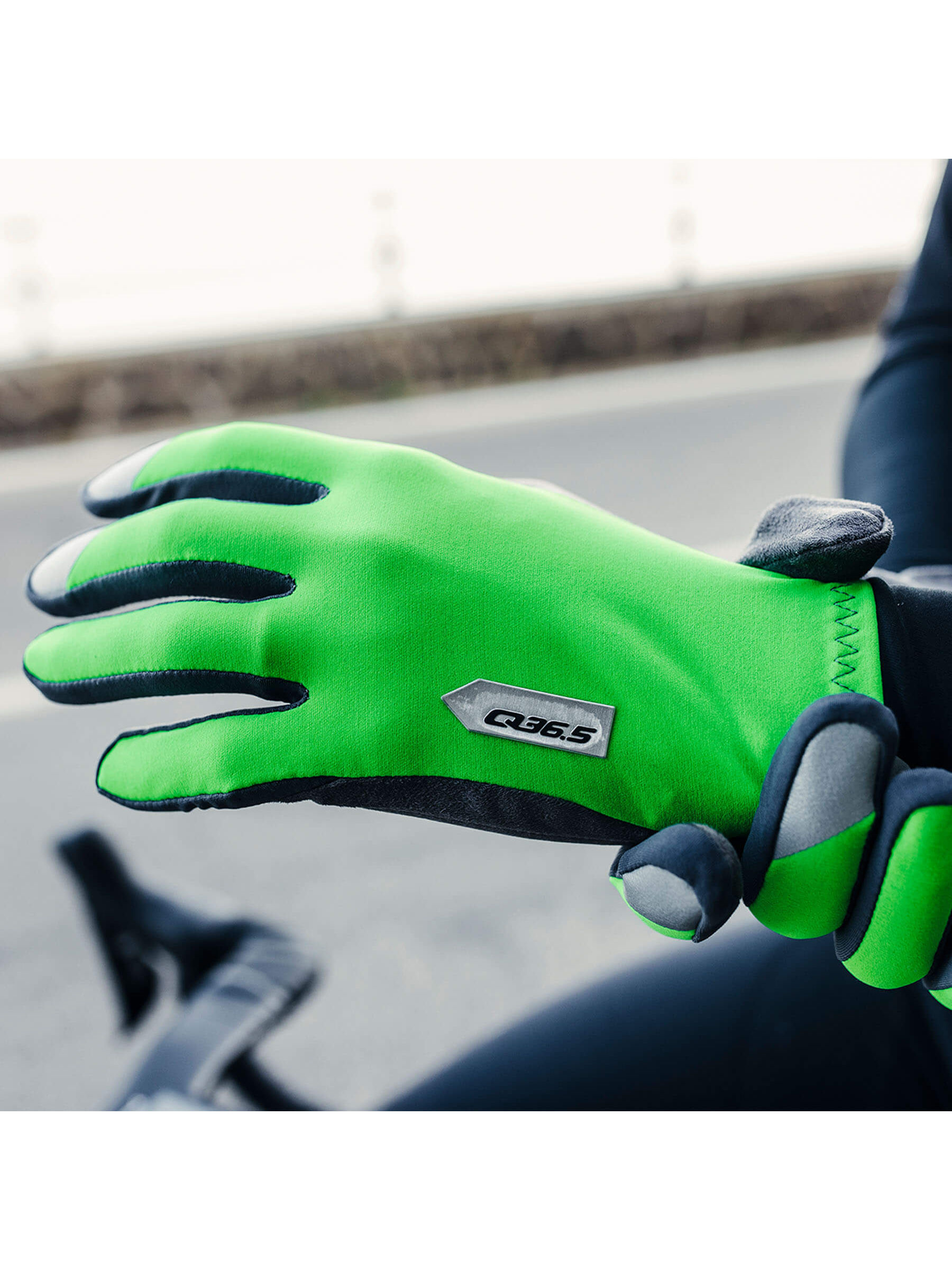 Cyclist showcasing the bright green Q36.5 Hybrid Que X Gloves while riding.