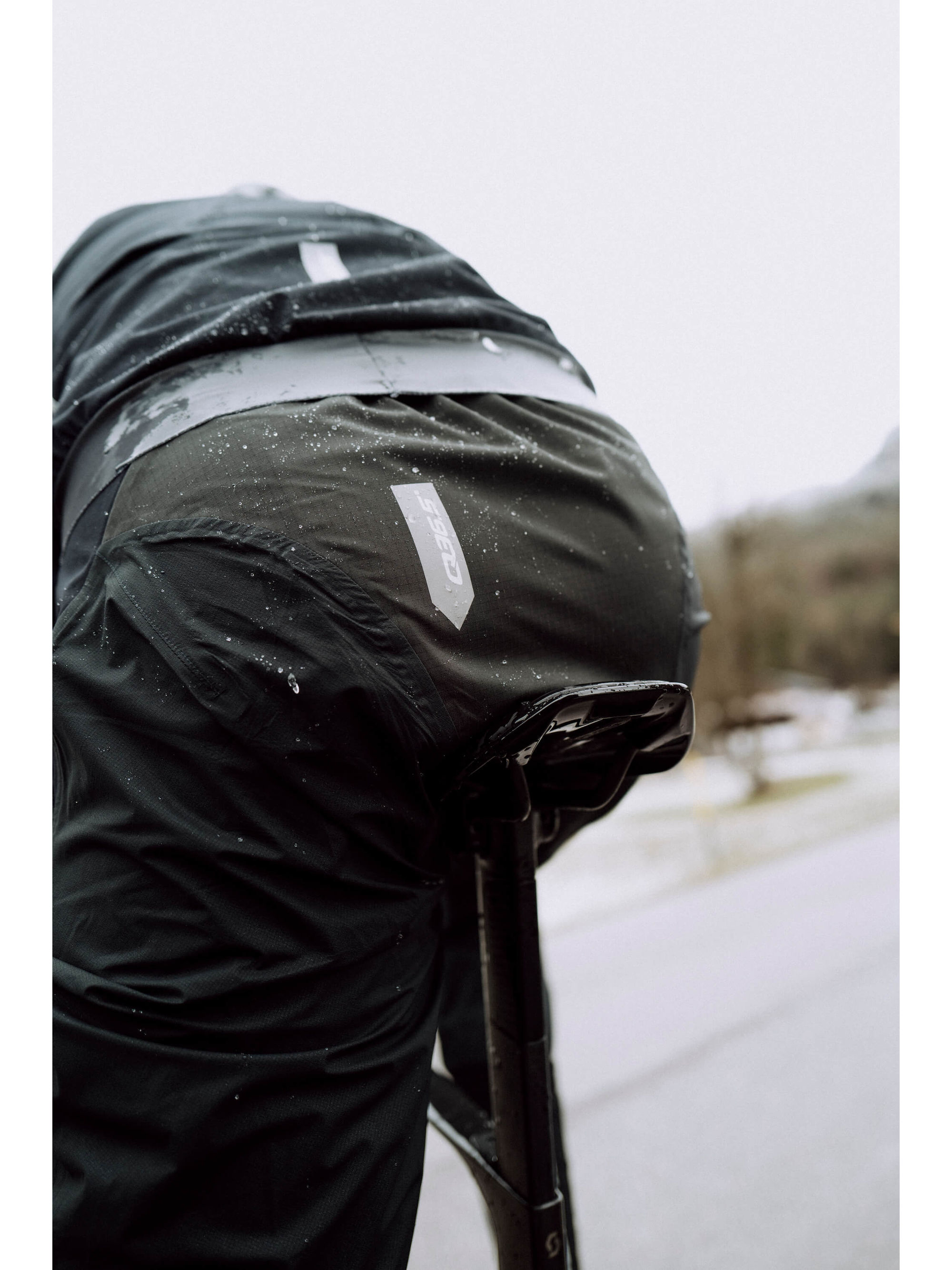 Close-up of Q36.5 Rain Overpants' back showing taped seams and abrasion-resistant area.