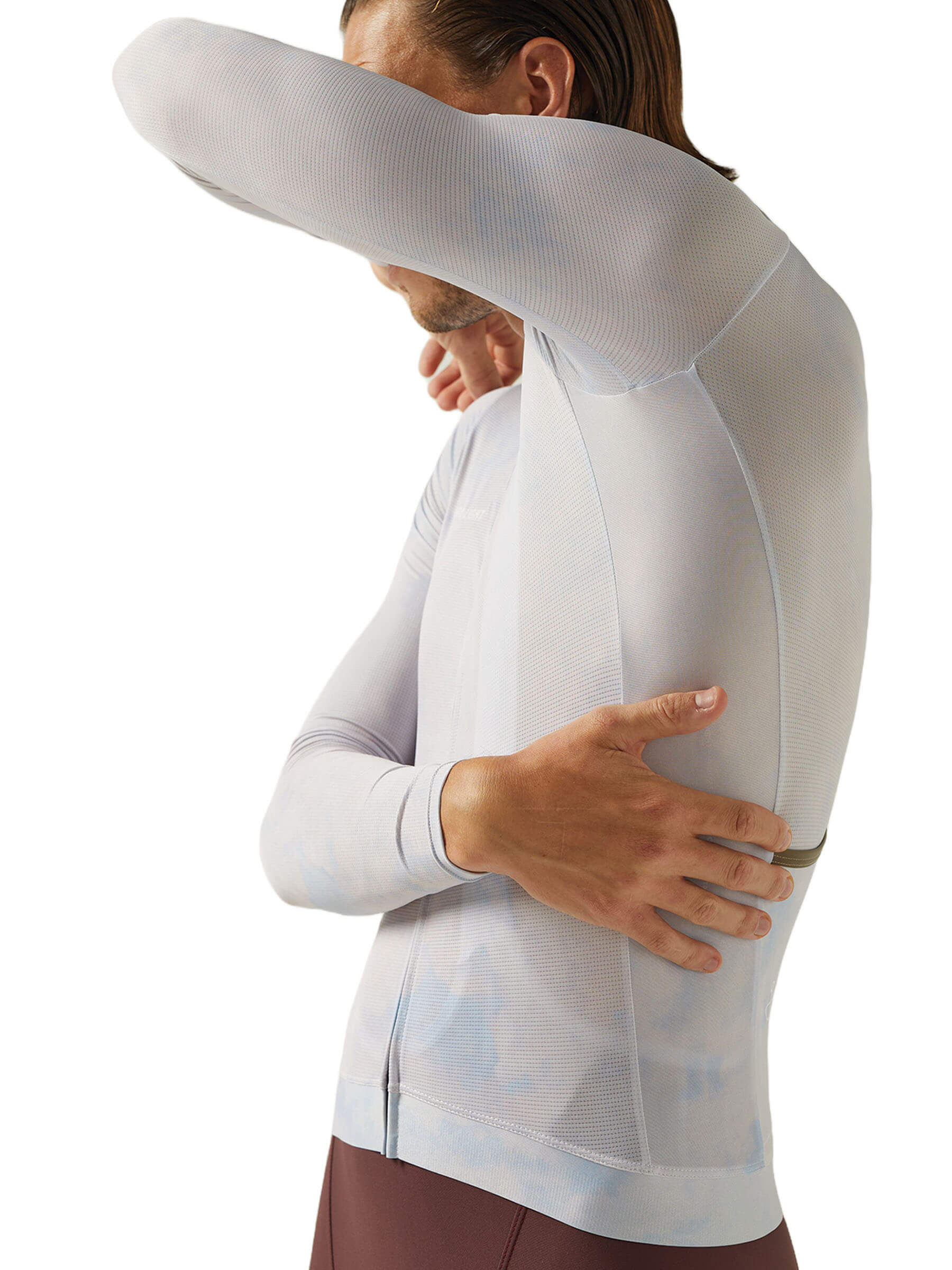 Side view of a cyclist wearing a Givelo long sleeve jersey, highlighting the fit and design.