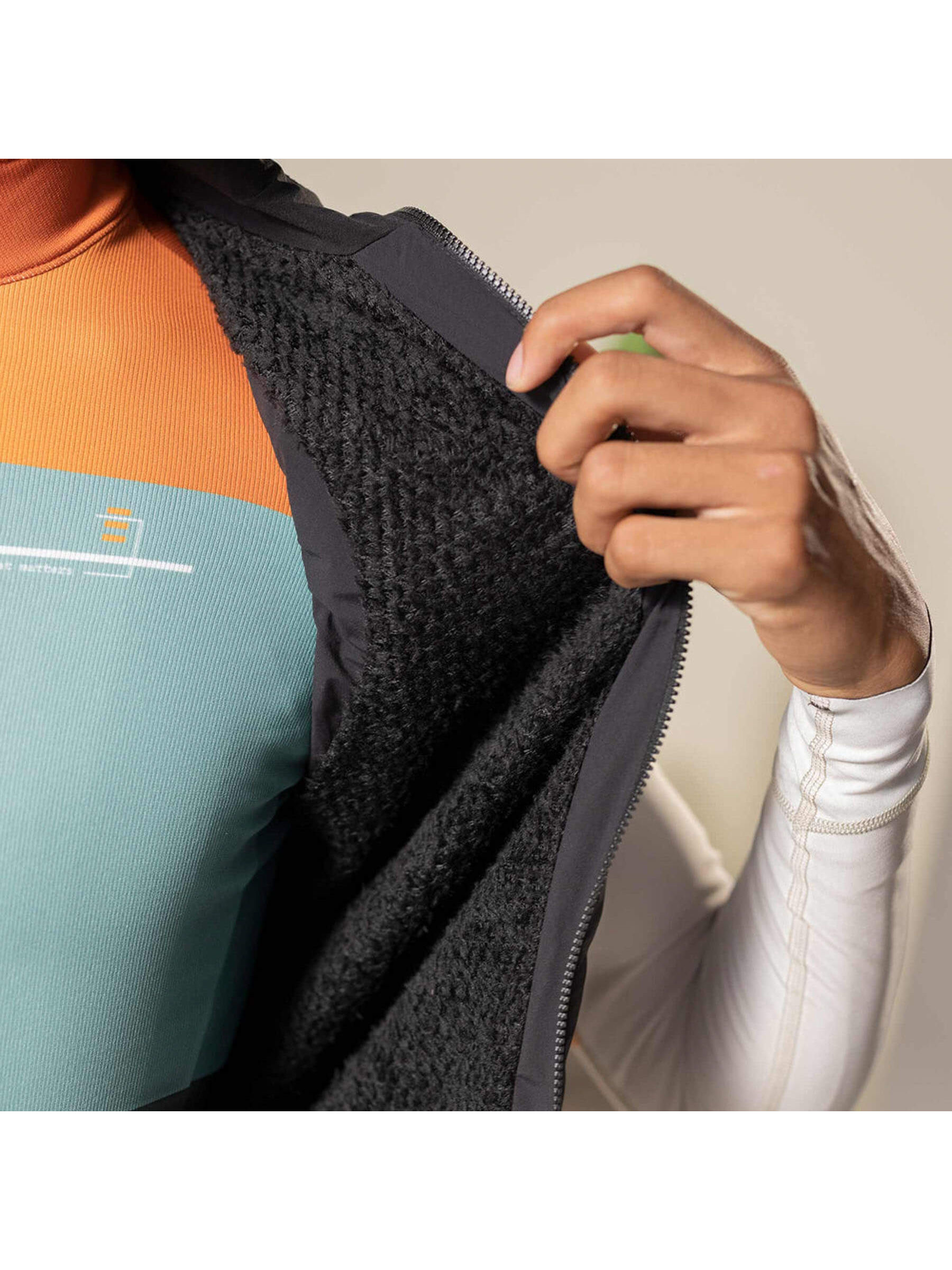 Close-up of Eminent black gilet interior, showcasing the Polartec® Alpha® insulation for warmth.