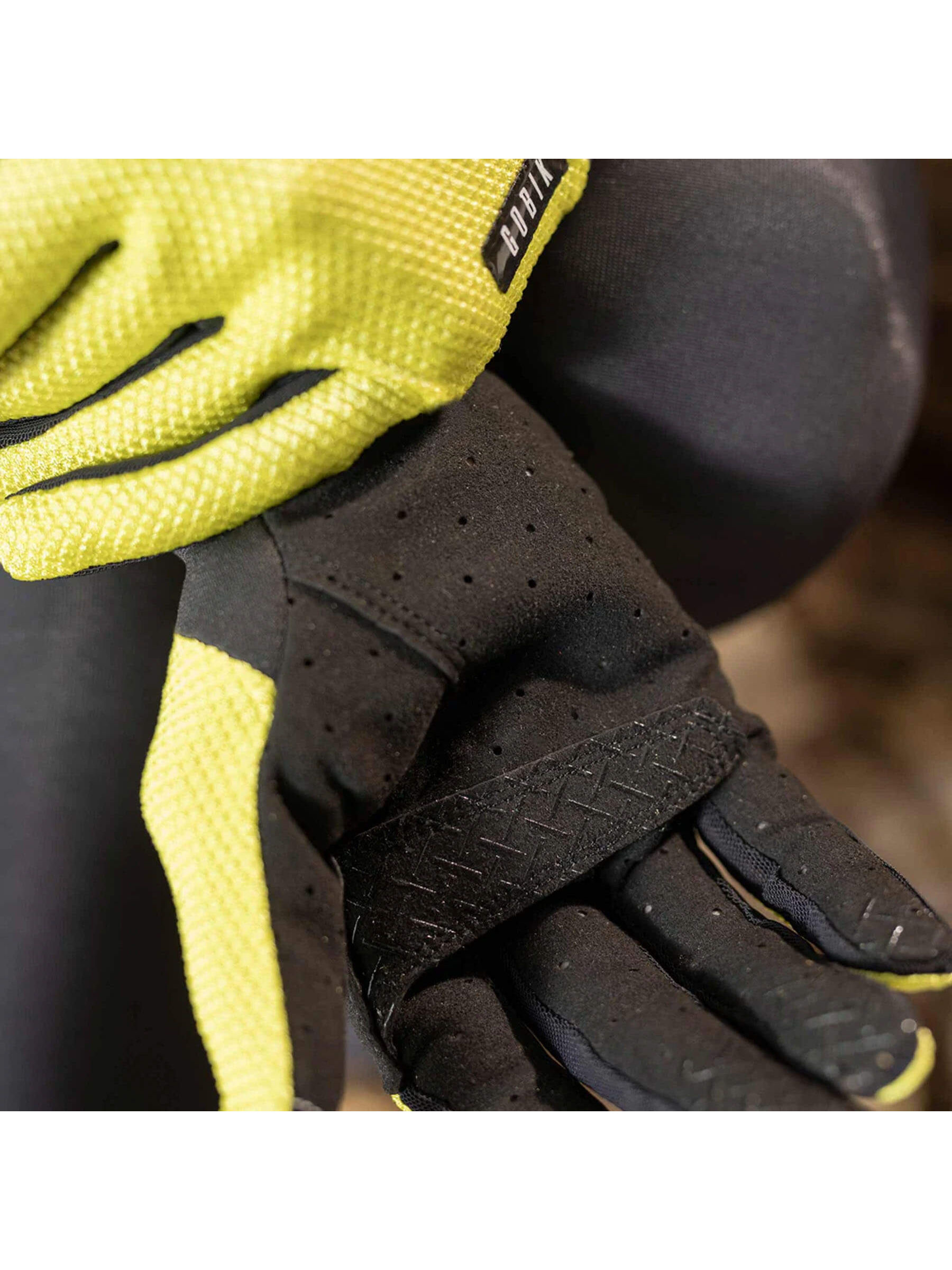 Citronell yellow GOBIK Lynx Gloves worn by a cyclist, emphasizing the fit and grip on the handlebars.