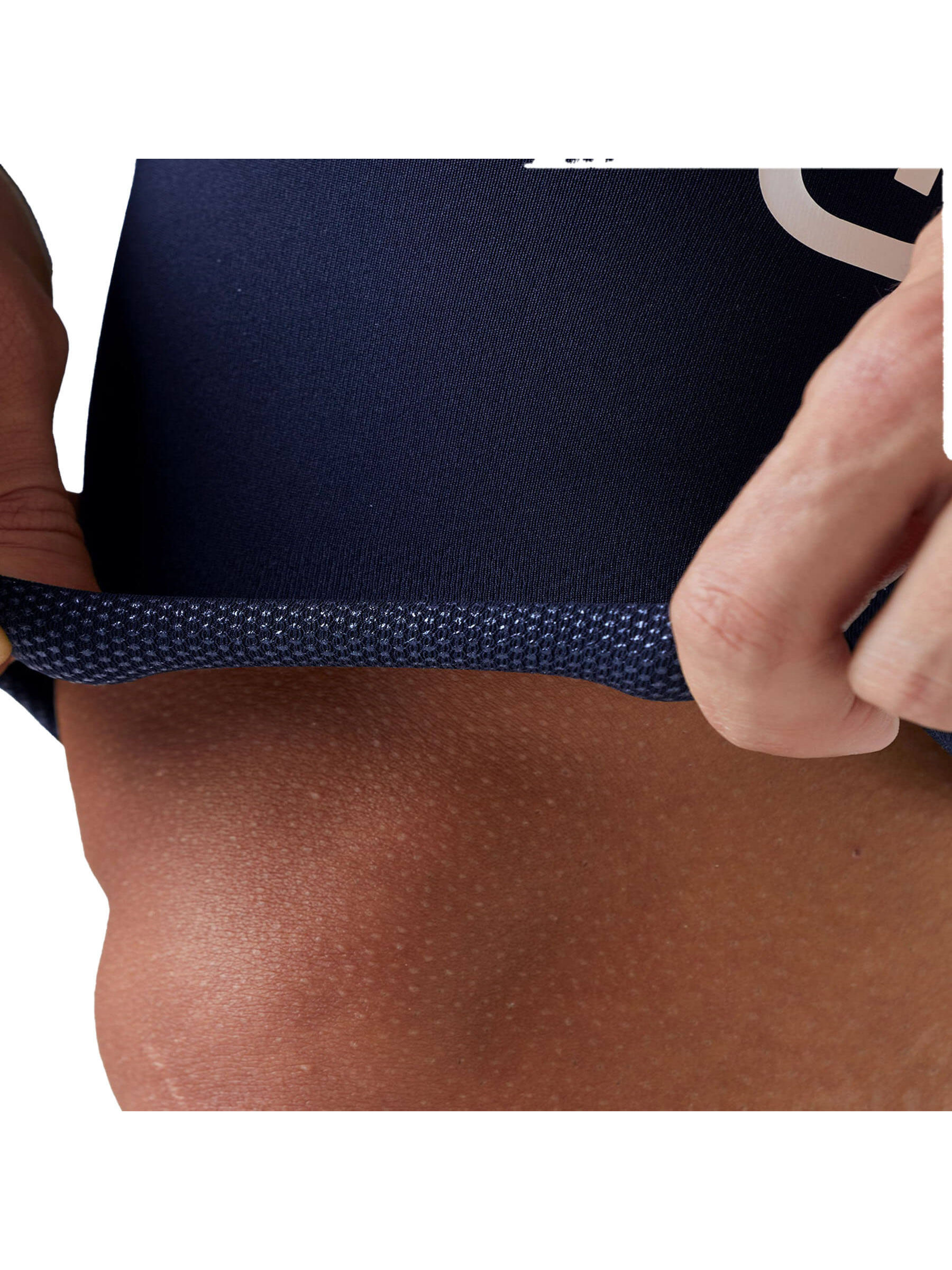 Close-up on the navy blue cycling shorts' leg hem with intricate textured fabric and the Givelo logo visible.