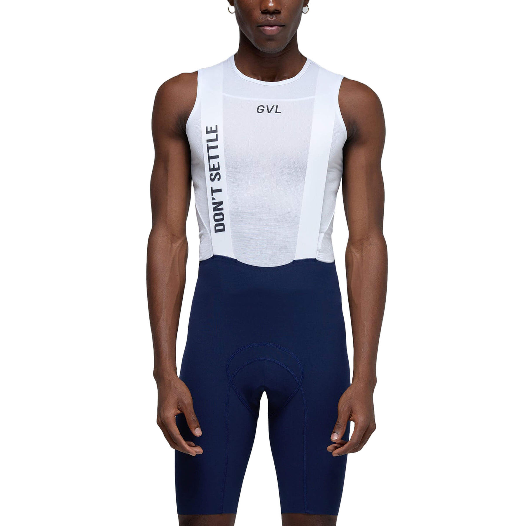 Front view of the man standing straight, showcasing the full design of the white bib shorts with the Givelo logo and navy blue cycling shorts.