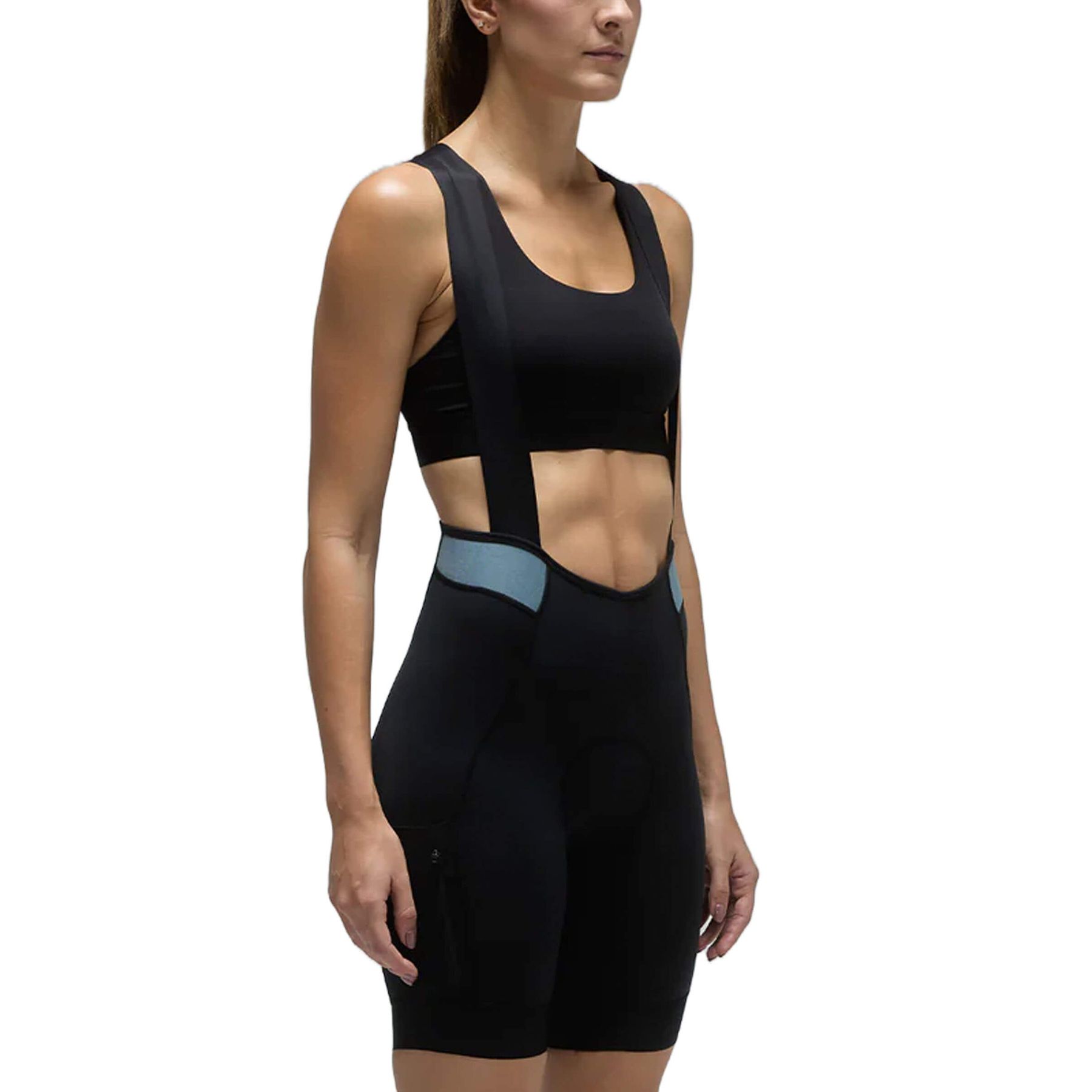 Woman in black Givelo MC Cargo Bib Shorts with blue accents, designed for cycling comfort.