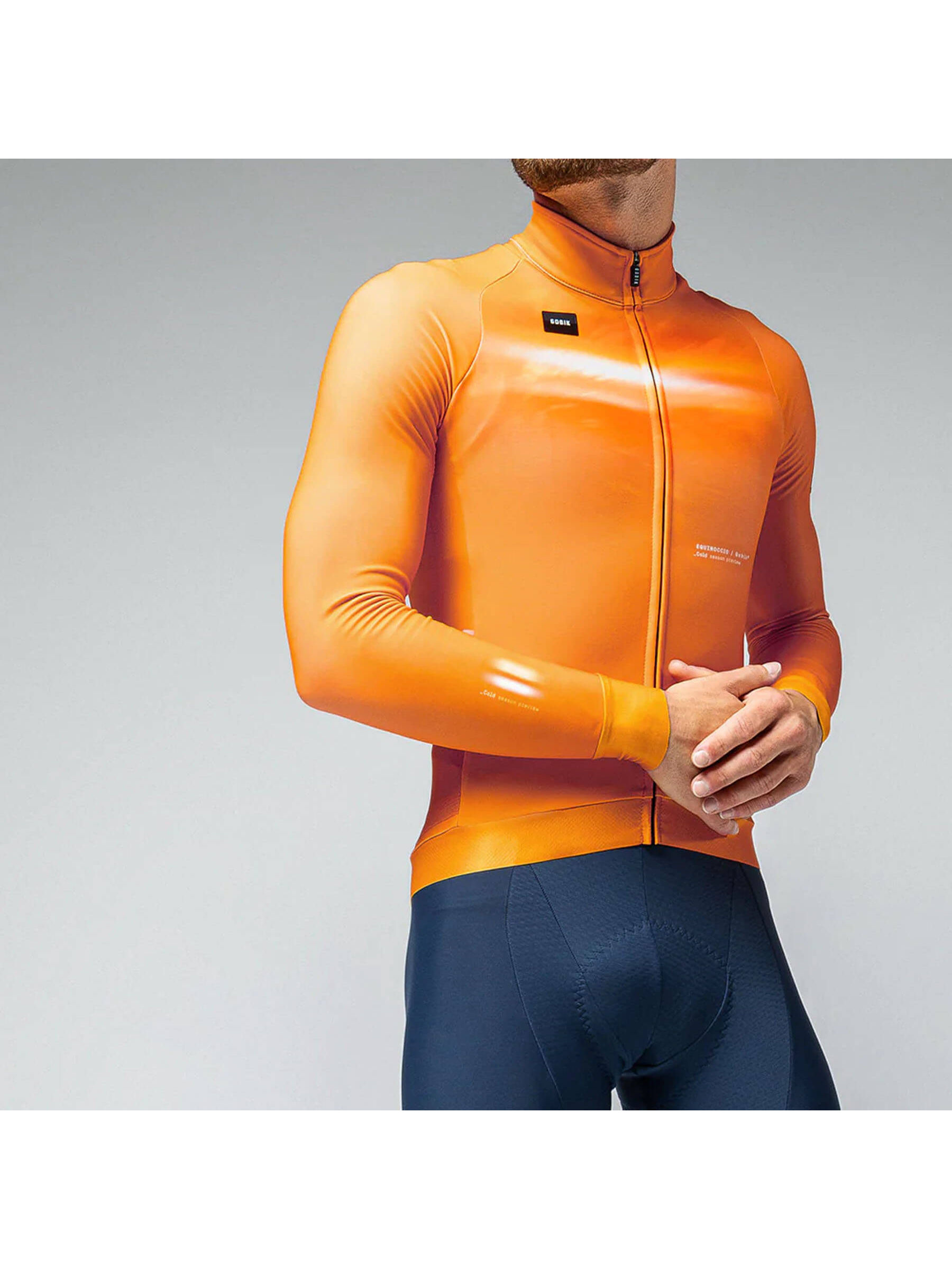 Man in GOBIK Hyder jersey featuring a cheddar hue with snug sleeves and a fitted silhouette for cold cycling.