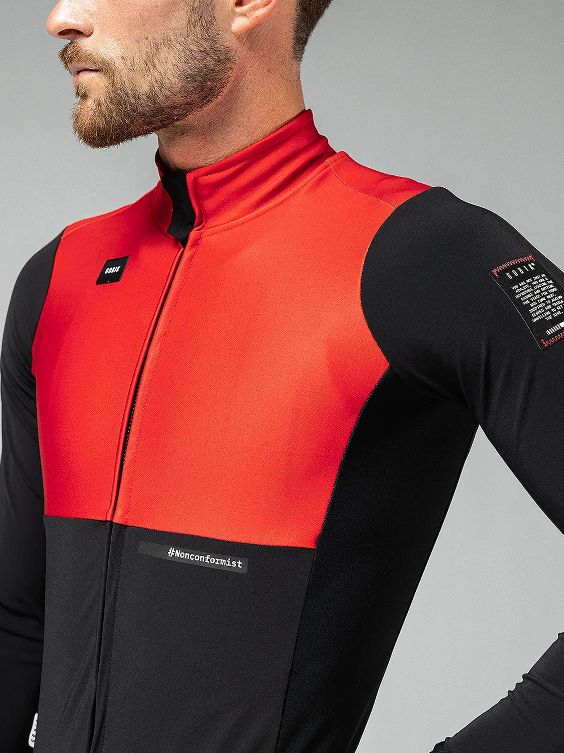 A cyclist wearing a red and black jacket with eVent® DVstretch™ insulating membrane for optimal wind resistance and aerodynamics.