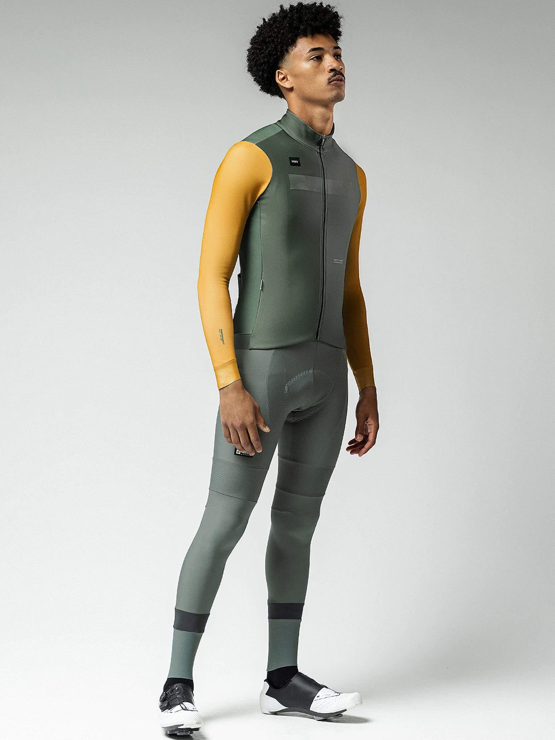 Male cyclist modeling Superhyder Fowler jersey, side view, displaying its fit and flexibility for dynamic cycling.
