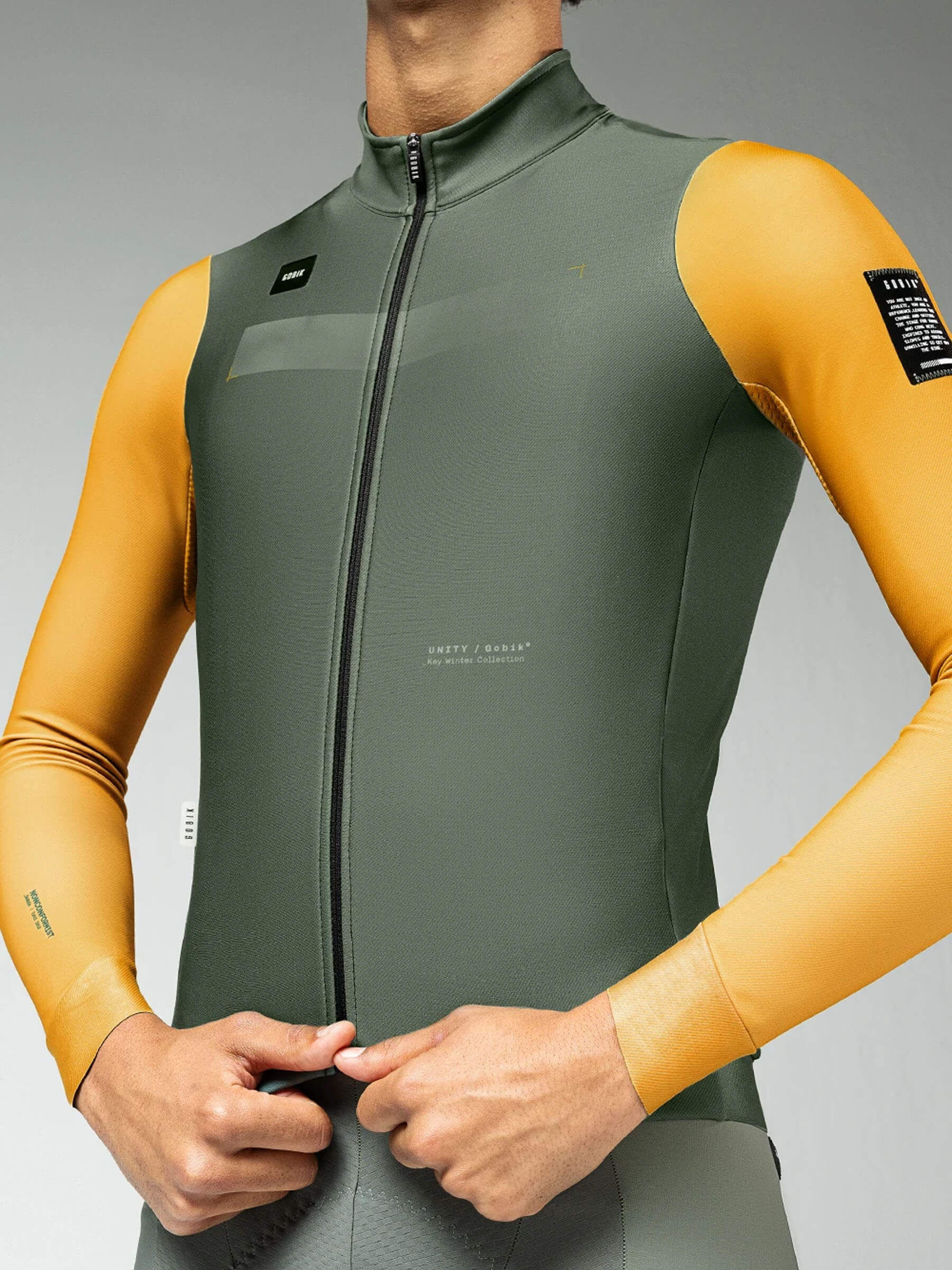 Close-up of Superhyder Fowler jersey as cyclist adjusts zipper, highlighting its aerodynamic fit and comfort.