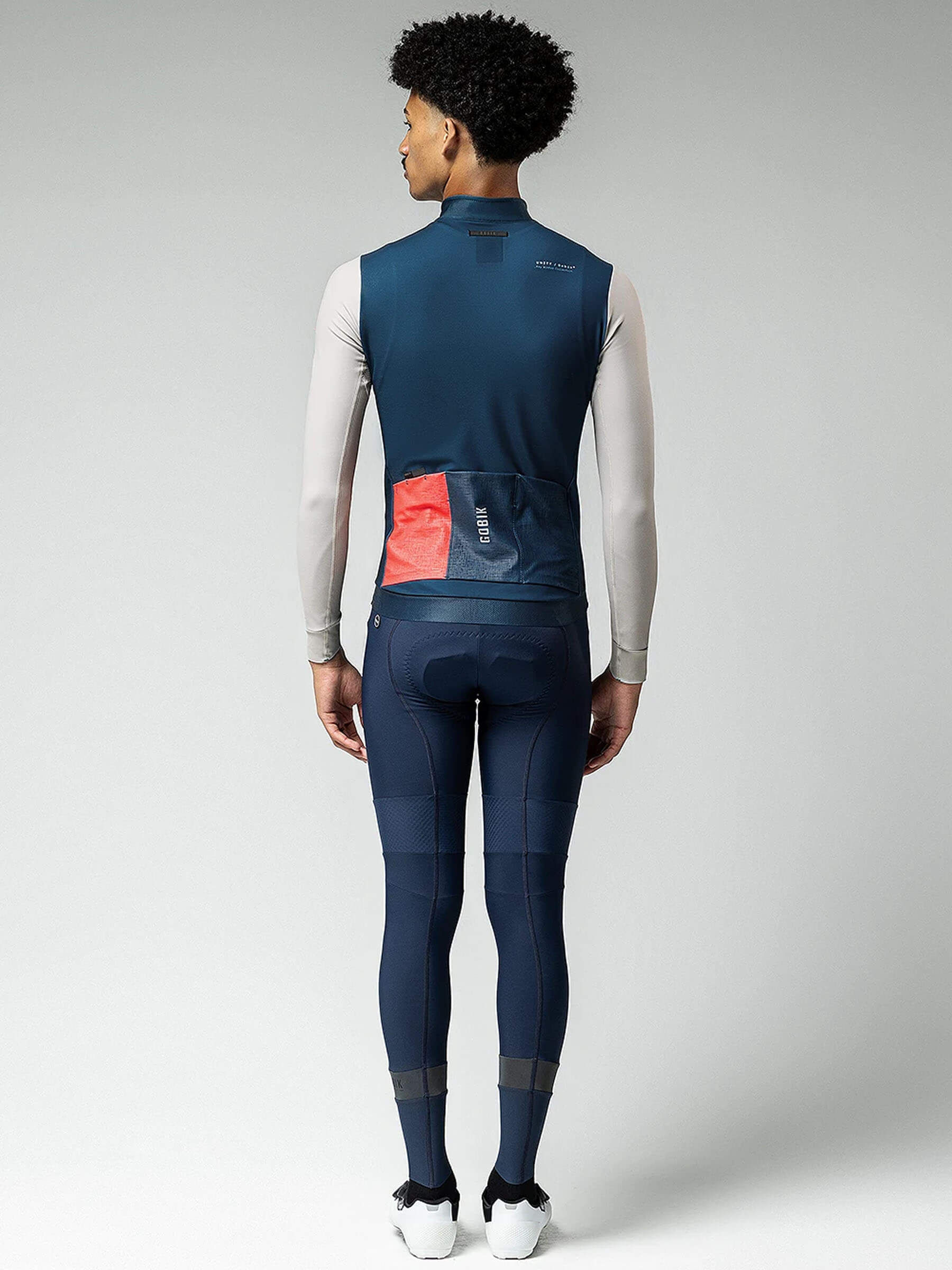 Rear shot of cyclist wearing Superhyder jersey with eVent® tech in varied weather.
