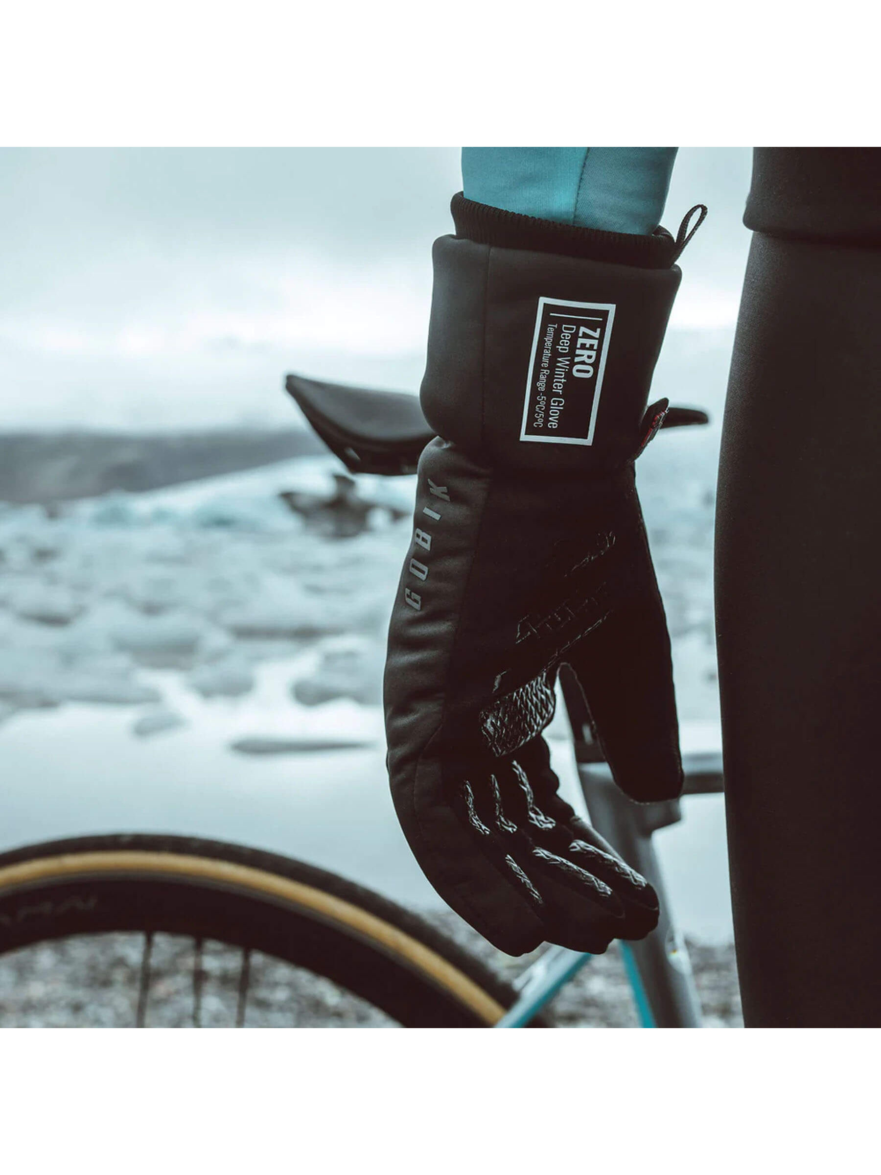 Primaloft Zero Thermal Gloves by GOBIK, hanging from a bike, showcasing their utility in cold weather.